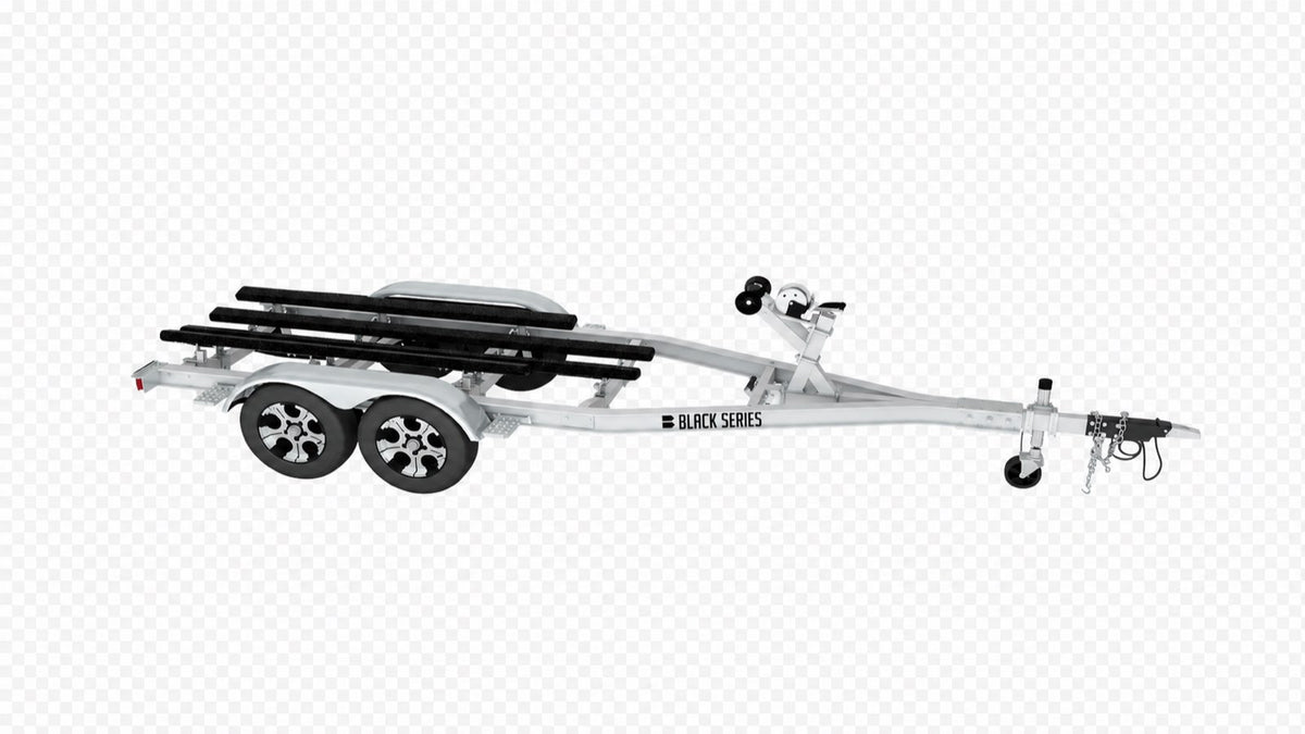 Side view of a 25 ft tandem axle aluminum boat trailer with black bunk boards and winch stand