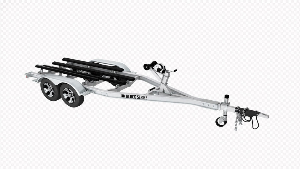 Three-quarter view of a tandem axle aluminum boat trailer with bunk supports and fenders